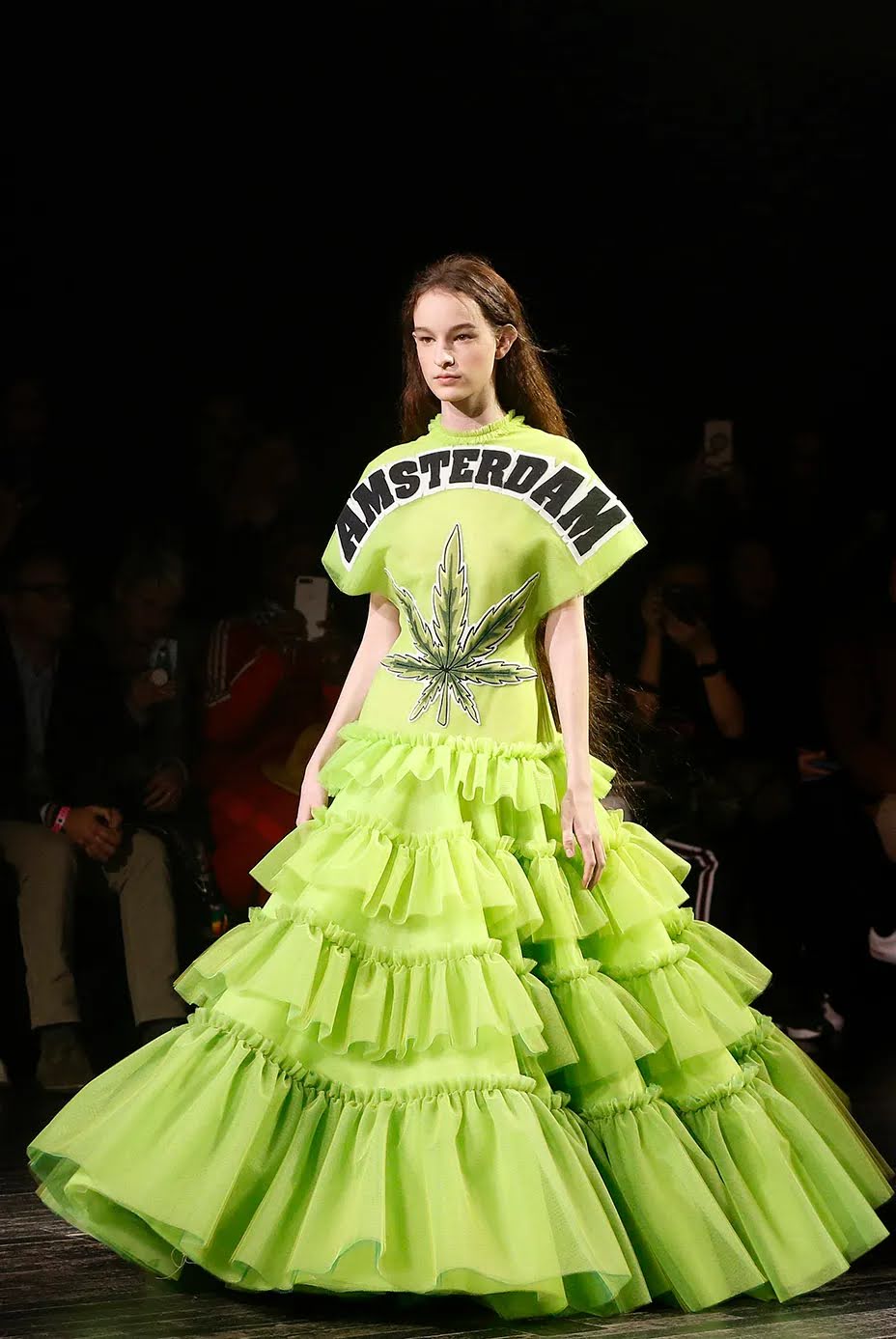A model from amsterdam walking down the runway while wearing a hemp printed dress