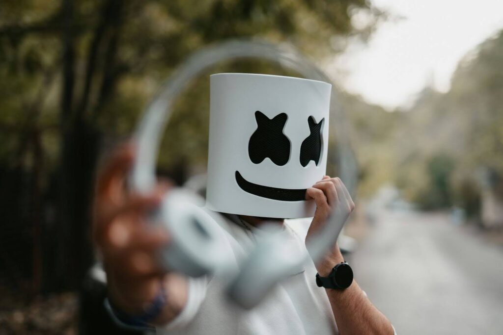 Focused image of Marshmallow handing you headphones